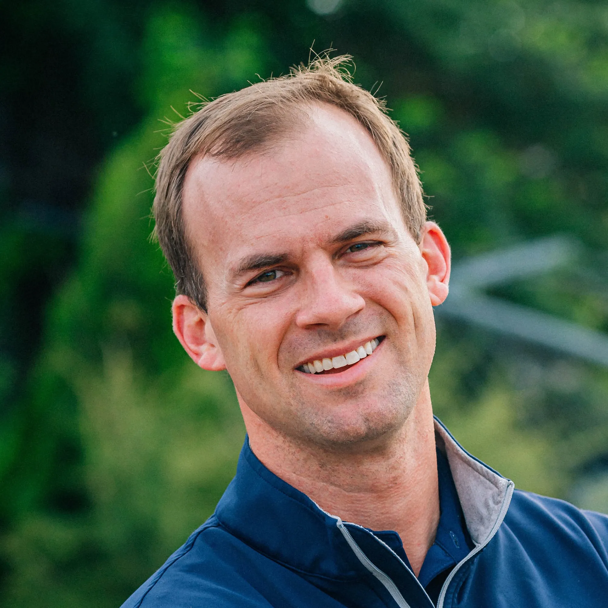 Hall Simmons of Southern Acre, smiling, in a navy quarter-zip